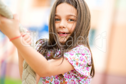 Cute little girl is playing in playground