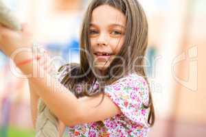 Cute little girl is playing in playground