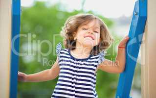 Cute little girl is playing in playground