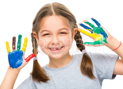 Portrait of a cute girl playing with paints