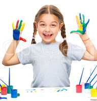 Portrait of a cute girl playing with paints