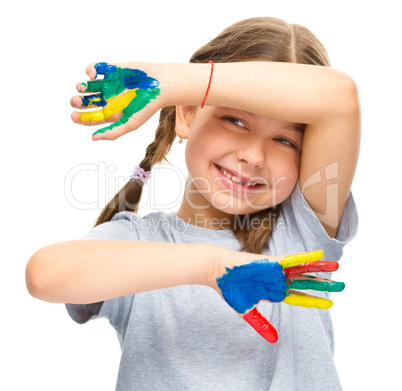 Portrait of a cute girl playing with paints