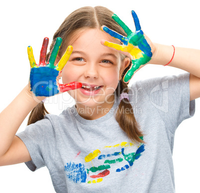 Portrait of a cute girl playing with paints