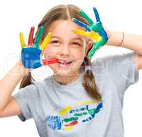 Portrait of a cute girl playing with paints