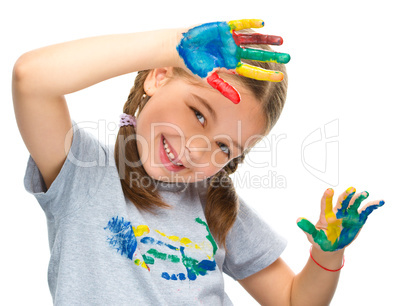 Portrait of a cute girl playing with paints