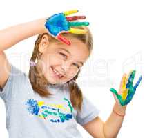 Portrait of a cute girl playing with paints