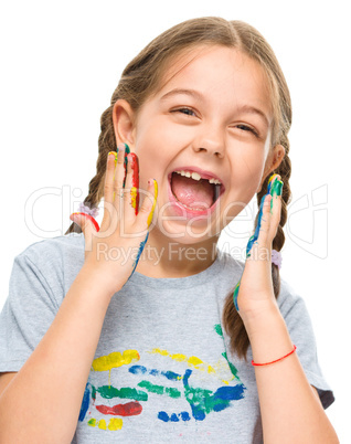 Portrait of a cute girl playing with paints