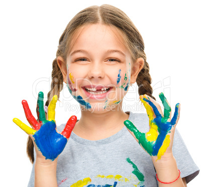 Portrait of a cute girl playing with paints