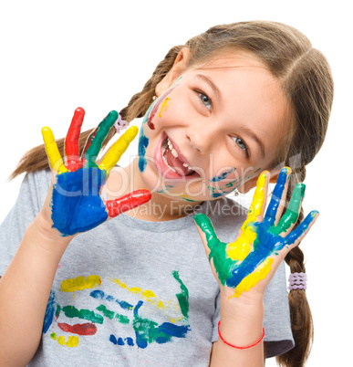 Portrait of a cute girl playing with paints