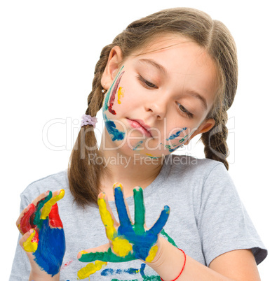 Portrait of a cute girl playing with paints