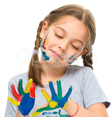 Portrait of a cute girl playing with paints