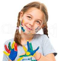 Portrait of a cute girl playing with paints