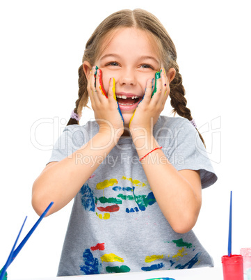 Little girl is holding her face in astonishment