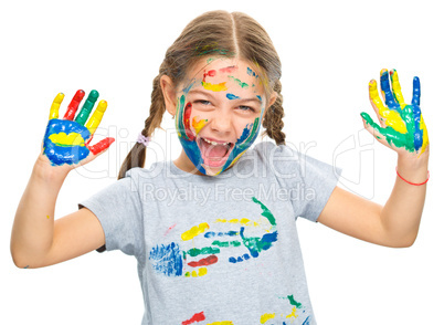 Portrait of a cute girl playing with paints