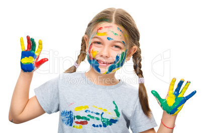 Portrait of a cute girl playing with paints