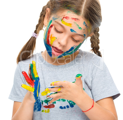 Portrait of a cute girl playing with paints