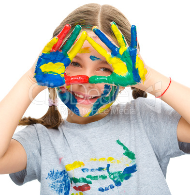 Portrait of a cute girl playing with paints