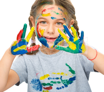 Portrait of a cute girl playing with paints