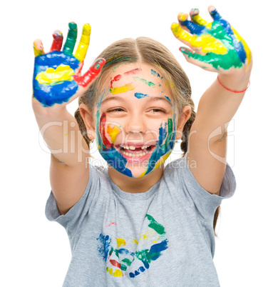 Portrait of a cute girl playing with paints