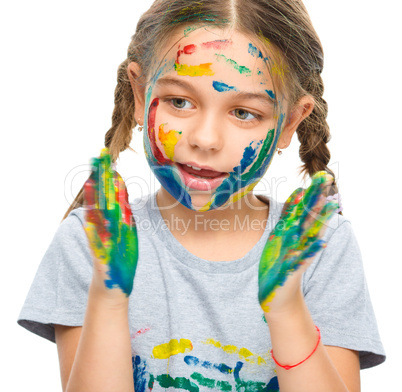 Portrait of a cute girl playing with paints