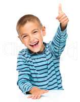 Little boy is showing thumb up sign