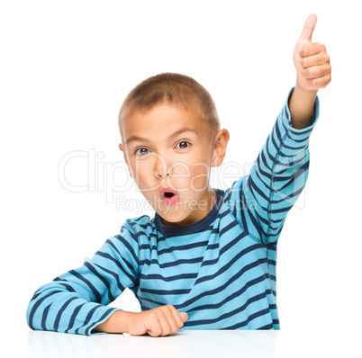 Little boy is showing thumb up sign