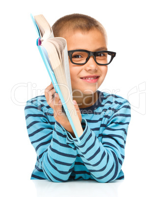 Little boy is reading a book