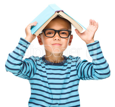 Little boy plays with book