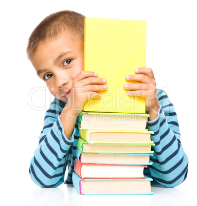 Little boy plays with book