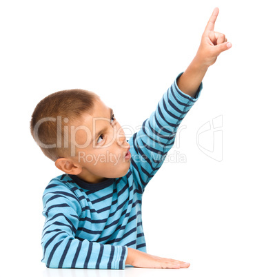 Little boy is pointing up using his index finger