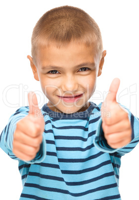 Portrait of a cute boy showing thumb up sign