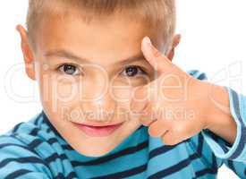 Little boy is showing thumb up sign