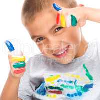 Portrait of a cute boy playing with paints