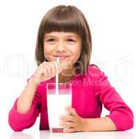 Cute little girl with a glass of milk