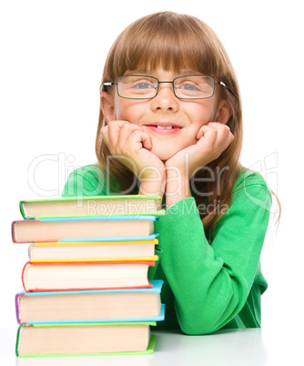 Little girl with a pile of books