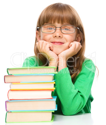 Little girl is reading a book