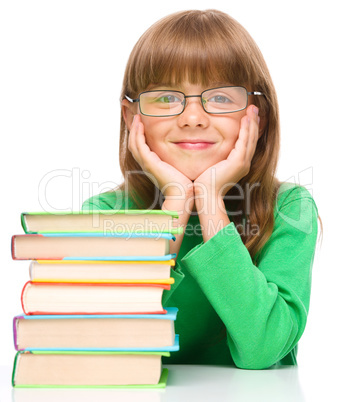 Little girl is reading a book