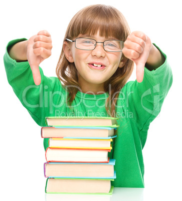 Little girl is reading a book