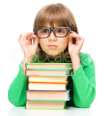 Little girl is reading a book