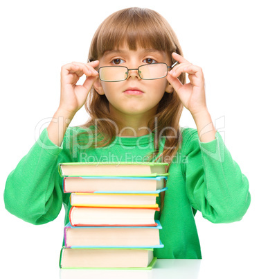 Little girl is reading a book