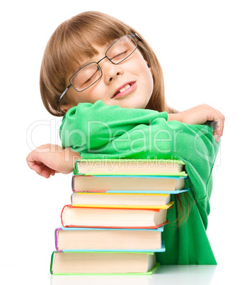 Little girl is sleeping on her books