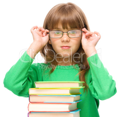 Little girl is reading a book