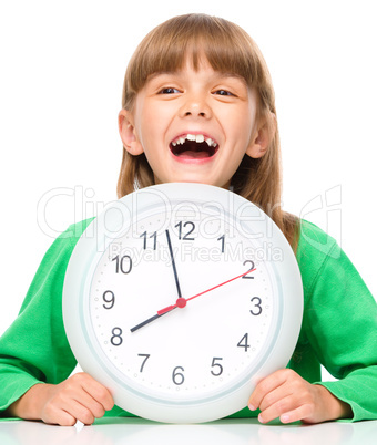 Little girl is holding big clock