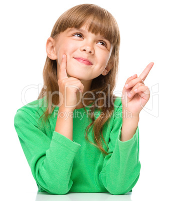 Portrait of a young girl pointing up