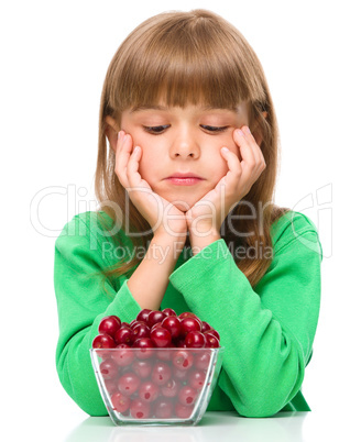 Cute girl doesn't want to eat cherries