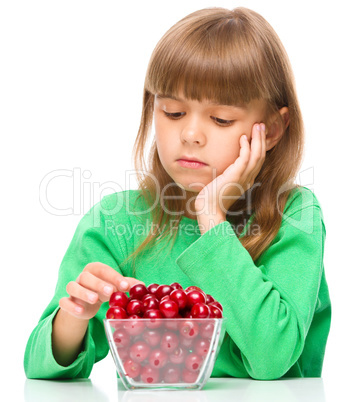 Cute girl doesn't want to eat cherries