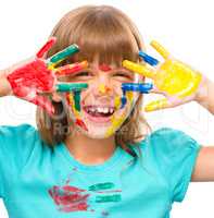 Portrait of a cute girl playing with paints