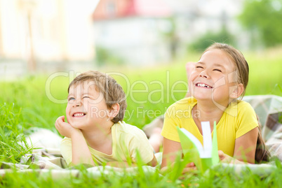Little girl and boy are playing outdoors