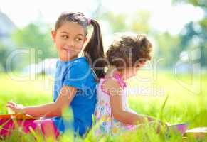 Two little girls are reading books