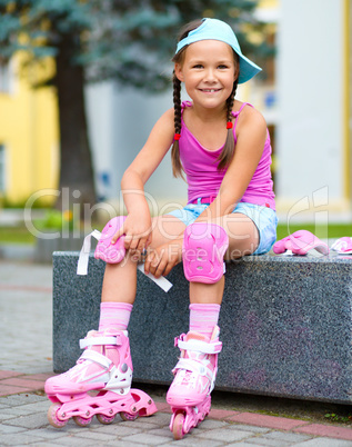 Little girl is wearing roller-blades